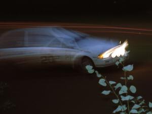 Steve Potter / Jeff Delahorne scream along just after sundown in their Mazda 323GTX.