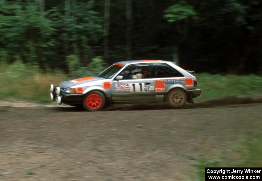 Jeff Zwart / Cal Coatsworth in their Mazda 323GTX at a hairpin.