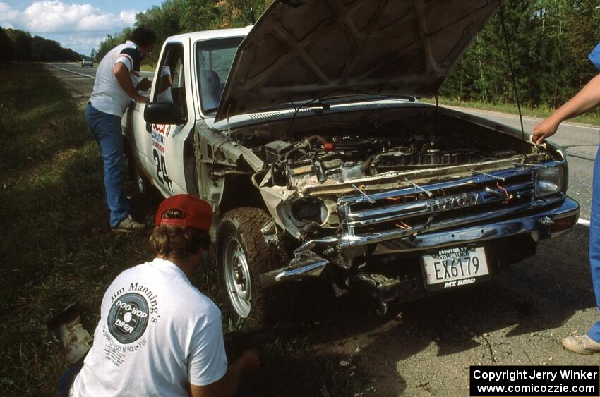 Rusty Campbell / John McArthur survey damage to their Toyota Pickup. Unfortunately they were unable to restart.