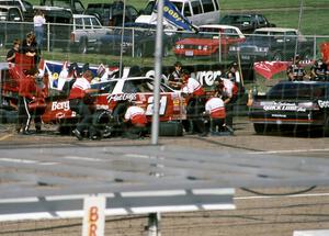 Johnny Benson, Jr.'s Chevy Lumina and Mike Eddy's Pontiac Grand Prix during a pit stop