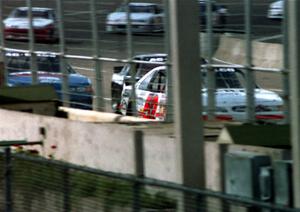 Butch Miller's Ford Thunderbird leads the field to the start/finish line