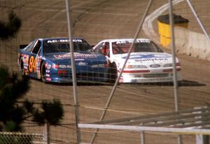 (84) Bob Senneker's Ford Thunderbird and (52) Butch Miller's Ford Thunderbird go side-by-side