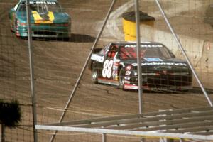 Mike Eddy's Pontiac Grand Prix and David Anspaugh's Olds Cutlass come out of turn 4