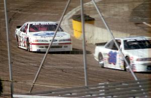 (52) Butch Miller's Ford Thunderbird about to put a lap on (36) Cindy Peterson's Chevy Lumina