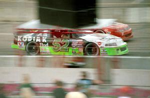 Ken Schrader's Chevy Lumina and Gary St. Amant's Ford Thunderbird head down the front straight