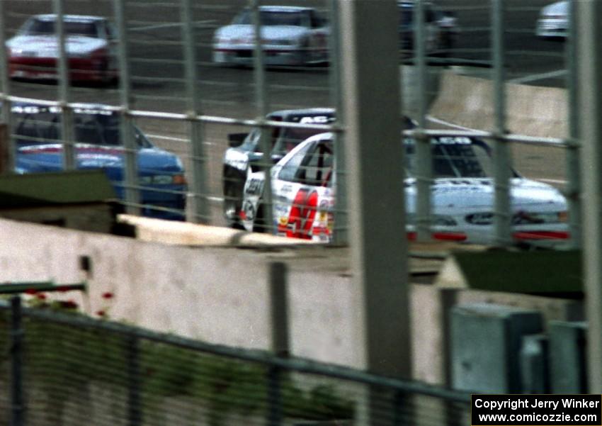 Butch Miller's Ford Thunderbird leads the field to the start/finish line