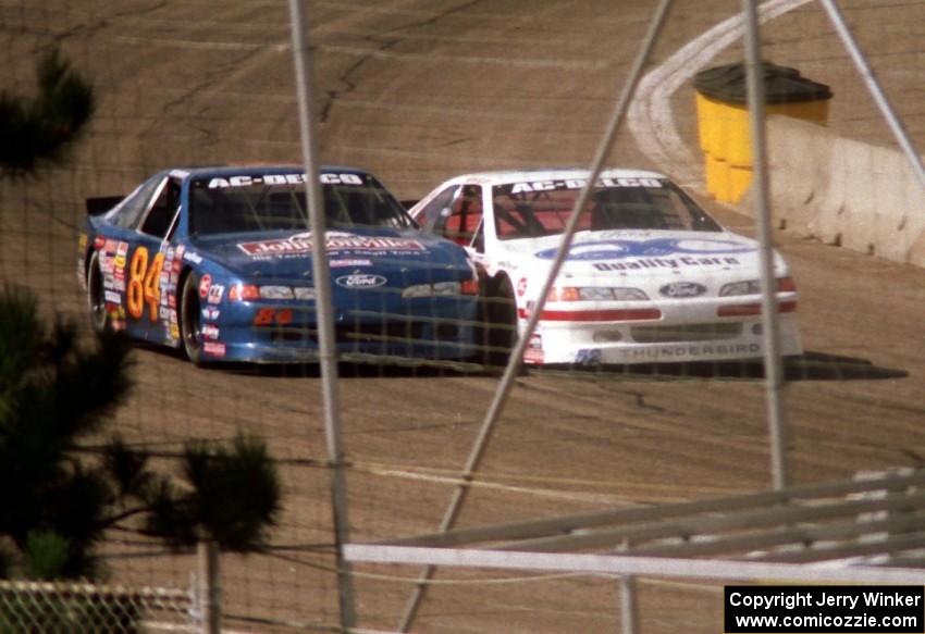 (84) Bob Senneker's Ford Thunderbird and (52) Butch Miller's Ford Thunderbird go side-by-side