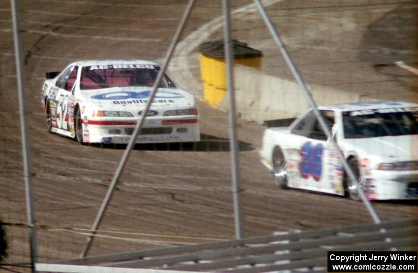 (52) Butch Miller's Ford Thunderbird about to put a lap on (36) Cindy Peterson's Chevy Lumina