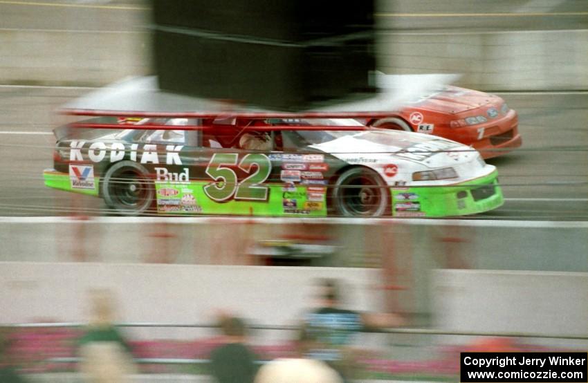 Ken Schrader's Chevy Lumina and Gary St. Amant's Ford Thunderbird head down the front straight