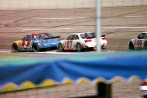 (2) Bobby Gill's Pontiac Grand Prix and (87) Tony Raines' Pontiac Grand Prix