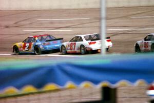 (2) Bobby Gill's Pontiac Grand Prix and (87) Tony Raines' Pontiac Grand Prix