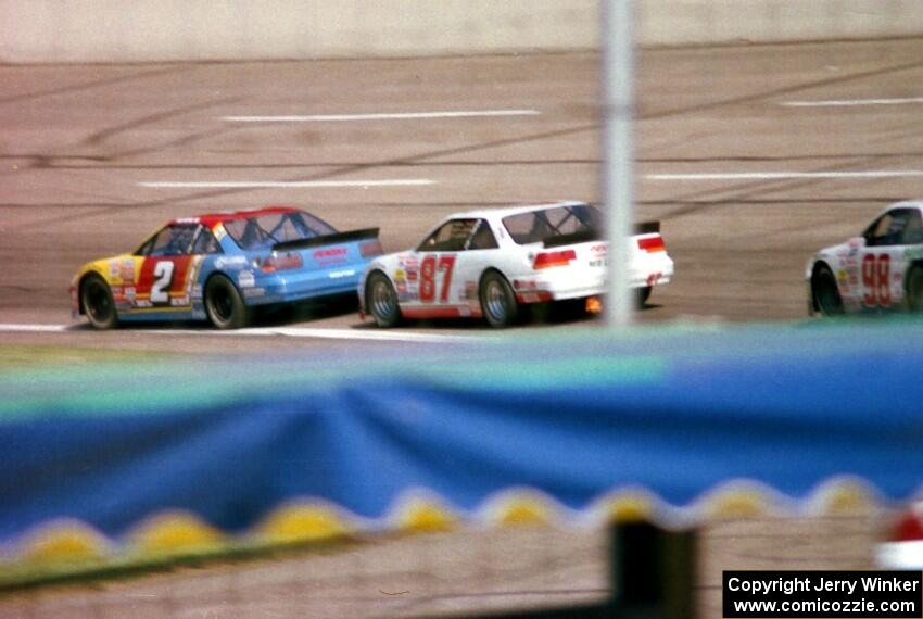 (2) Bobby Gill's Pontiac Grand Prix and (87) Tony Raines' Pontiac Grand Prix