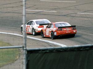 (87) Tony Raines' Pontiac Grand Prix and (18) Mike Miller's Pontiac Grand Prix