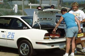 Steve Hess packs up his G-Stock Pontiac Sunbird as Norm Johnson stops by for a chat