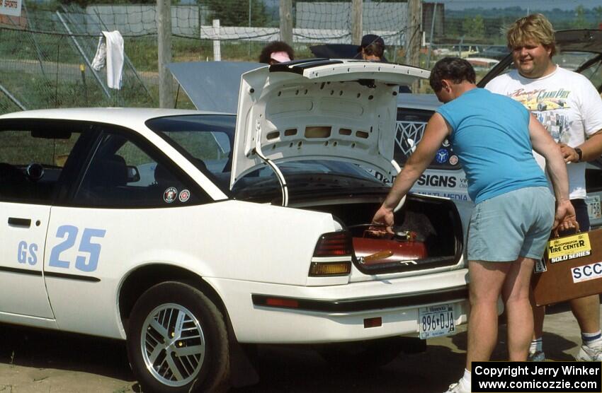 Steve Hess packs up his G-Stock Pontiac Sunbird as Norm Johnson stops by for a chat