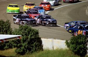 The lead pack streams through turn 4