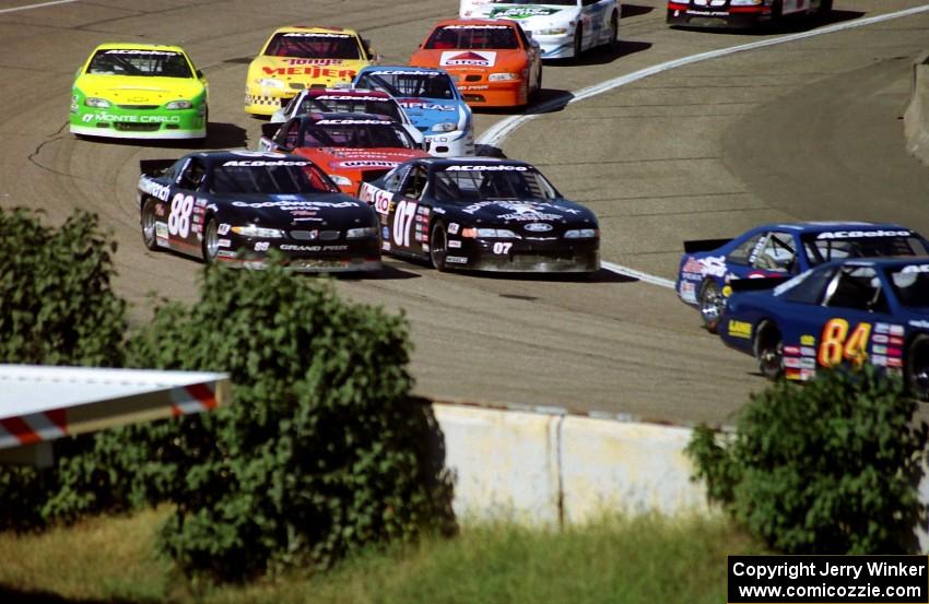 The lead pack streams through turn 4