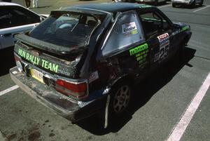 Tom Ottey / Pam McGarvey display damage from Friday night on their PGT Mazda 323GTX.