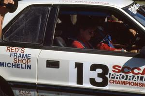 Cindy Krolikowski reads notes before laving the ceremonial start in her and her husband's (Henry Krolikowski) Dodge Shadow.