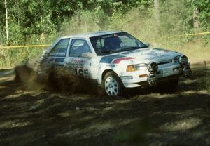 Shannon Millen / Jean Lindamood Mazda 323GTX blast dirt while taking a left-hand hairpin.