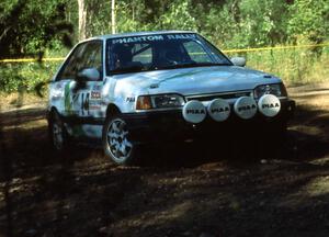 David Yein / Dave White take the slow approach through the hairpin in their open class Mazda 323GTX.