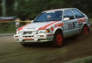 Jeff Zwart / Cal Coatsworth Mazda 323GTX dive downward through the crossroads.