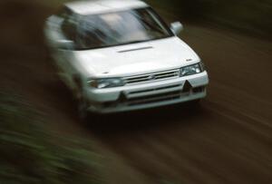 The new factory Subaru Legacy of Chad DiMarco / Erick Hauge flies down a tree-lined Blue Trail.