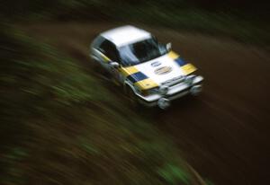 Noel Lawler / Charlie Bradley in their PGT Mazda 323GTX come out of a right-hand sweeper.