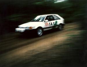 David Yein / Dave White fly past in their open class Mazda 323GTX.