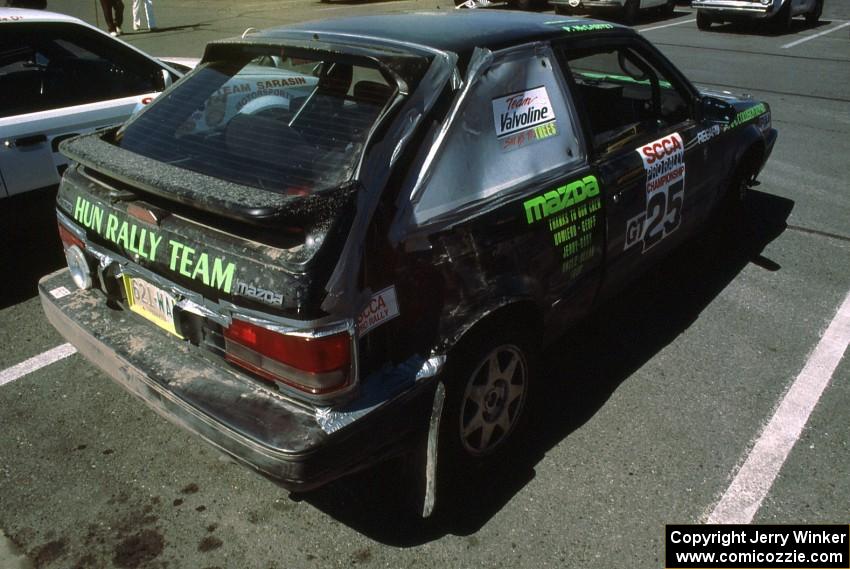 Tom Ottey / Pam McGarvey display damage from Friday night on their PGT Mazda 323GTX.