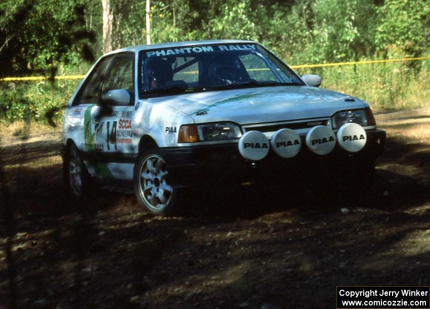 David Yein / Dave White take the slow approach through the hairpin in their open class Mazda 323GTX.