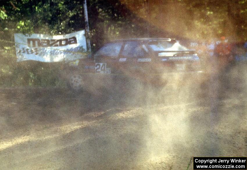 Carl Merrill / J. Jon Wickens spew silt off the wheels of their PGT Mazda 323GTX.
