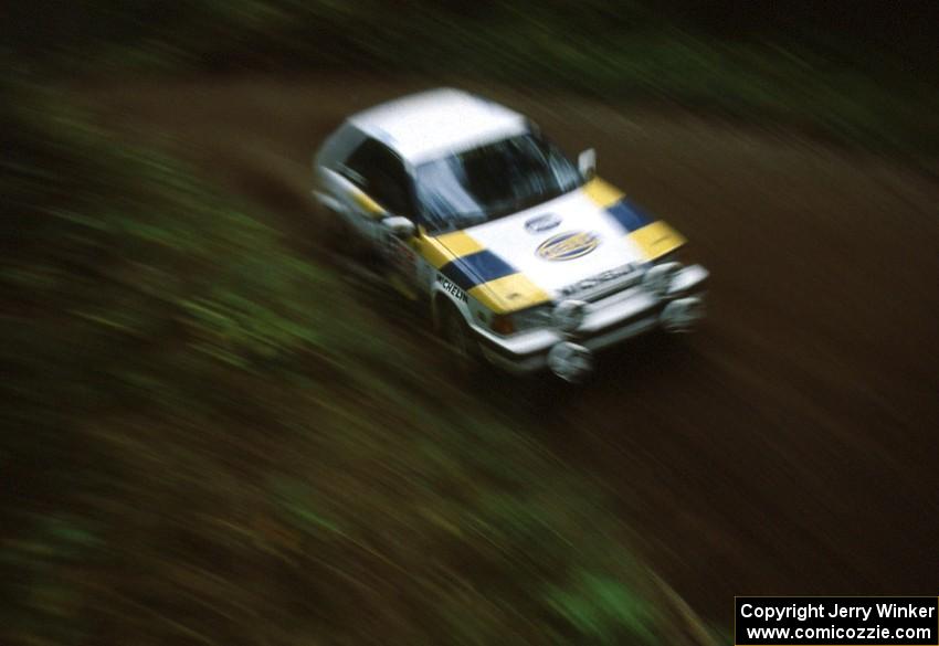 Noel Lawler / Charlie Bradley in their PGT Mazda 323GTX come out of a right-hand sweeper.