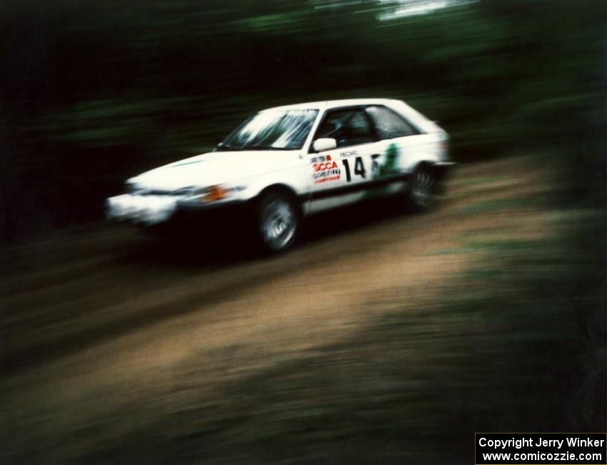 David Yein / Dave White fly past in their open class Mazda 323GTX.