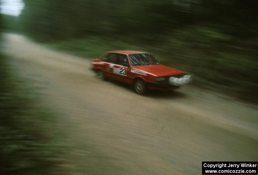 Jon Kemp / Gail McGuire in their Audi 4000 Quattro rocket down a straight.