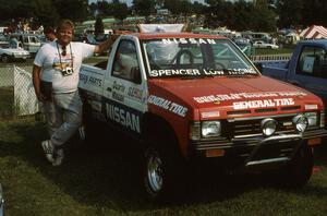 Norm Johnson leans on the Spencer Low Racing Nissan Pickup on display