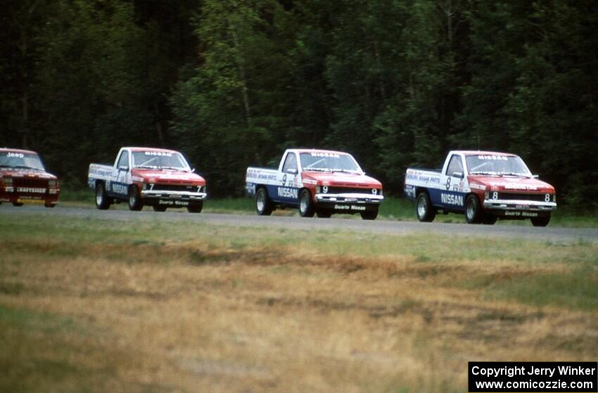 8) Ray Kong leads 9) Scott Gaylord, 7) Pepe Pombo all in Nissan Pickups