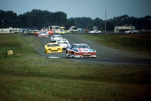 The field streams through turns 6 and 7 on lap one.