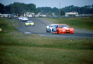 Five cars stream down between turns 6 and 7