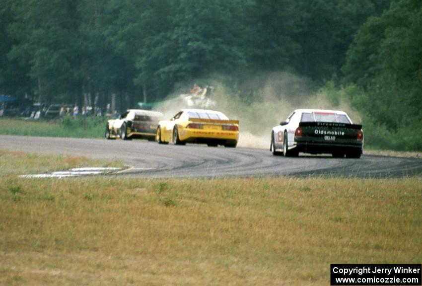 Robert Lappalainen's Ford Mustang is chased by Les Lindley's Chevy Camaro and Dick Danielson's Olds Cutlass Supreme