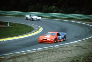 Tommy Kendall's Chevy Beretta leads Dorsey Schroeder's Ford Mustang through Canada Corner on lap one
