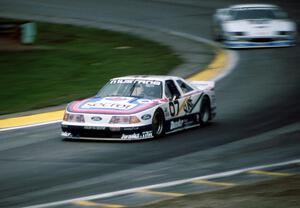 Lyn St. James' Ford Mustang chased by Jim Derhaag's Chevy Camaro