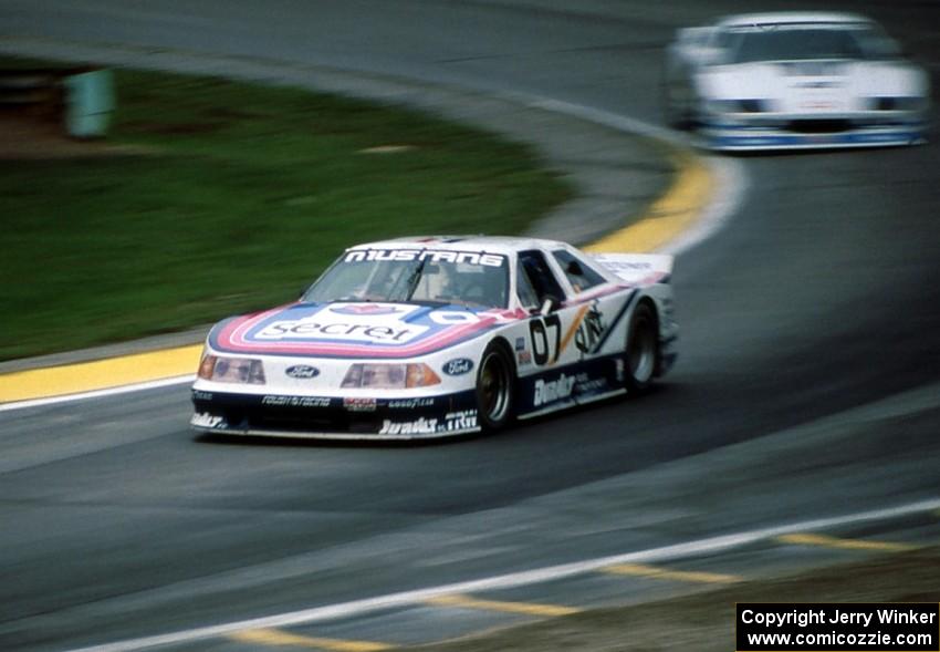 Lyn St. James' Ford Mustang chased by Jim Derhaag's Chevy Camaro