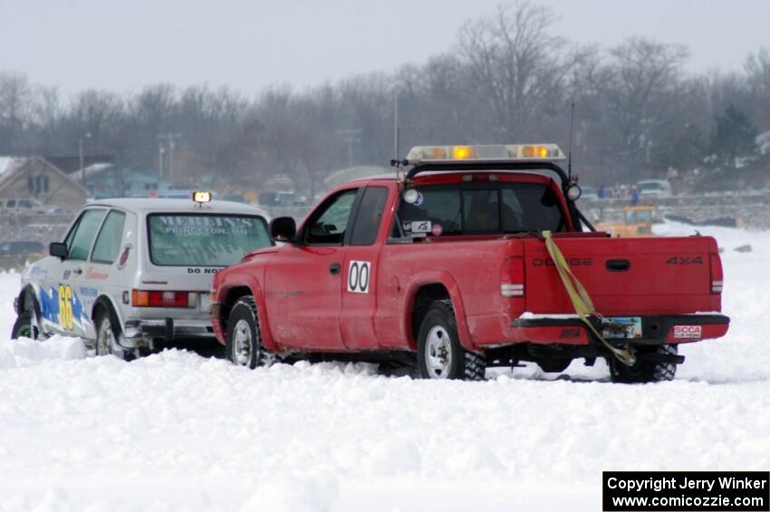 Jim Anderson's Dodge Ram Pickup tries to get the stranded Bucky Weitnauer VW Rabbit off the bank.