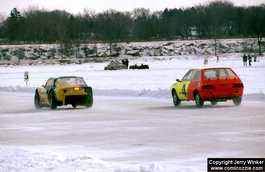 Jim King's Mazda Wankel-powered SAAB Sonnet III and Adam Popp's Dodge Colt go side-by-side entering turn two