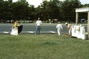 Kathy Maleck, John Dahlmeier, and others clean up the corner 10 flagstand at the end of the day.