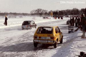 Dick Schneider / Todd Schneider / Ron Martinsow VW Rabbit DNF'ed as the John Barron / Jeff Delahorne VW GTI passes by in the pit