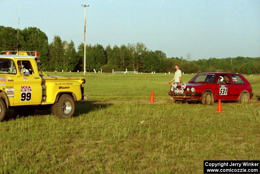 Brenda Corneliusen, in J.B. Niday's VW GTI, gets pulled out of the muck by Dan MacDonald's Chevy Pickup as John Parker watches.