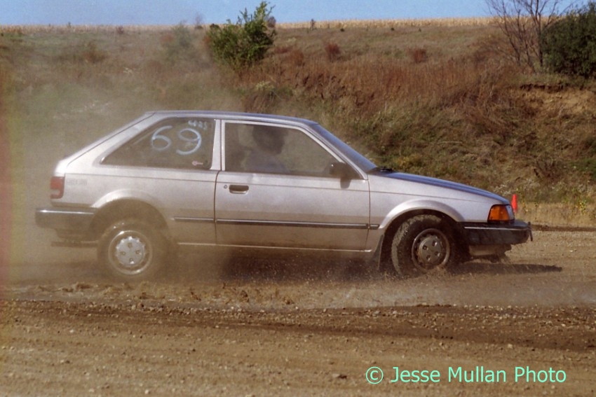 Jerry Winker's Mazda 323SE has a high-speed off (after bottoming out the car in the previous shot).
