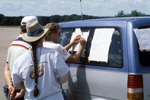 Jerome Sybrant writes down the scores as a few others check the scoreboards